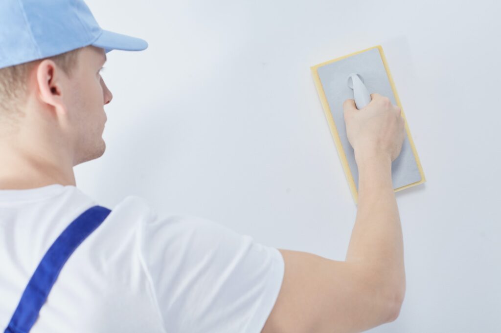 Worker with plastering trowel